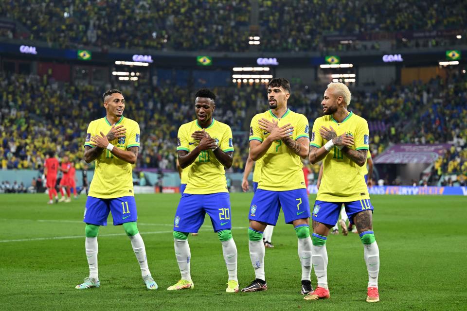 Brazilian teammates dance with Vinicius Junior (pictured second left) after a goal.