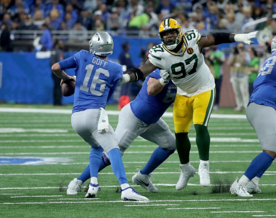 Detroit Lions quarterback Jared Goff is rushed by Green Bay Packers defensive tackle Kenny Clark during the first half at Ford Field, Thursday, Nov. 23, 2023.