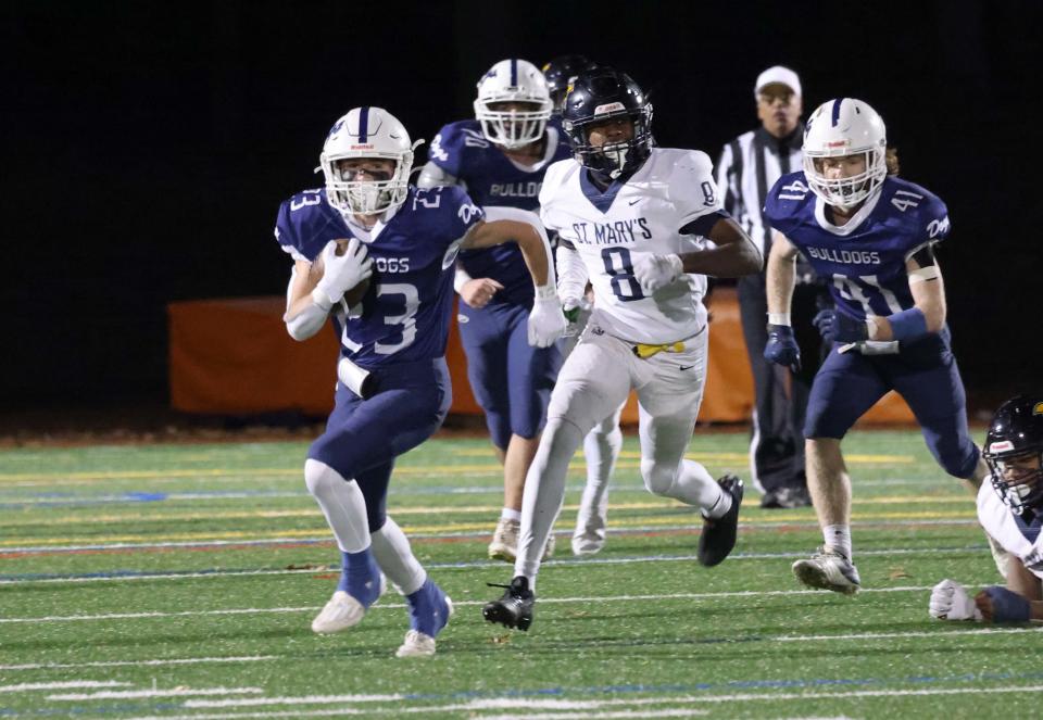 Rockland's Lucas Leander carries the football in the fourth quarter during a game versus St. Mary's at Walpole High School on Friday, Nov. 18, 2022.   