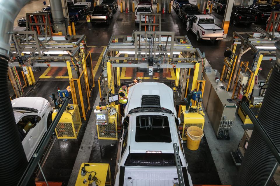 Workers check Ford F-150 trucks being built at the Ford Rouge Plant in Dearborn on Thursday, September 27, 2018.