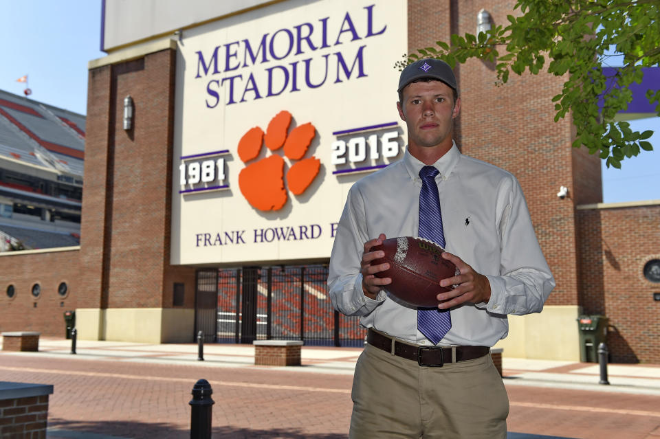 In this Monday, Aug. 27, 2018, photo, Furman quarterback and Clemson engineering student Harris Roberts poses for a photo on the Clemson campus, in Clemson, S.C. Roberts' worlds will collide on Saturday, Sept. 1 when he and his Furman teammates play at Clemson in the NCAA college football season opener for both teams. (AP Photo/Richard Shiro)