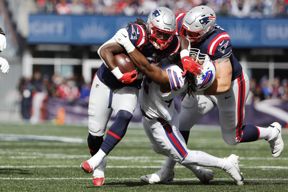 New England Patriots running back Rhamondre Stevenson (38) pushes away Buffalo Bills linebacker Dorian Williams (42) during the first half of an NFL football game, Sunday, Oct. 22, 2023, in Foxborough, Mass. (AP Photo/Winslow Townson)