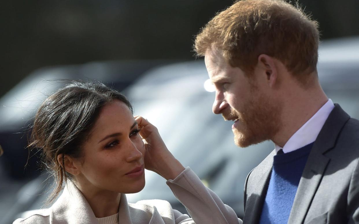 Like many modern newlyweds, Prince Harry and Meghan Markle will delay their honeymoon - AFP