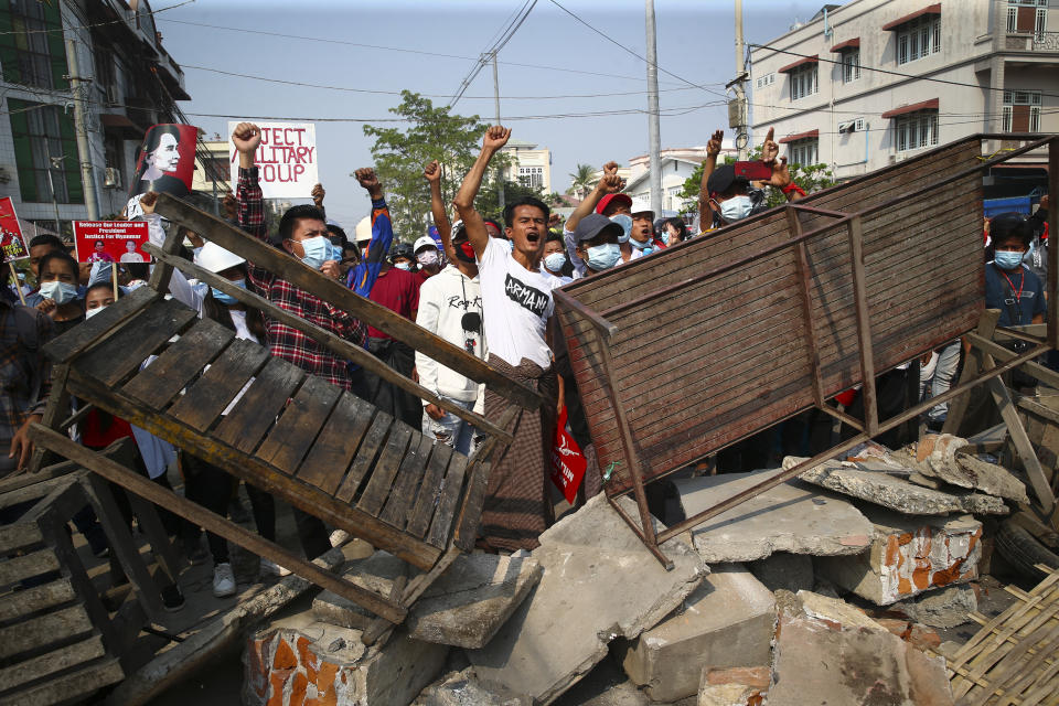 Protesters shout slogans as police arrive during a protest against the military coup in Mandalay, Myanmar, Sunday, Feb. 28, 2021. Police in Myanmar escalated their crackdown on demonstrators against this month's military takeover, deploying early and in force on Saturday as protesters sought to assemble in the country's two biggest cities and elsewhere. (AP Photo)