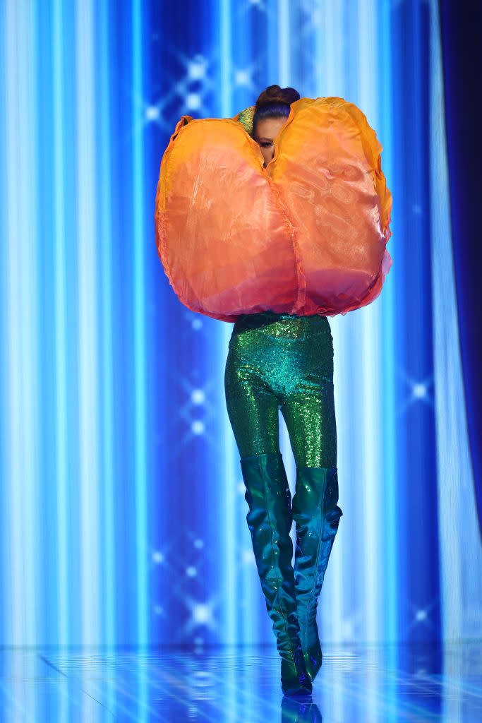 She's wearing shiny pants and a large tulip on top