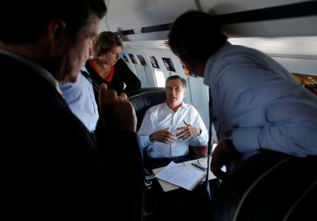 Mitt Romney talks to senior advisors Peter Flaherty, Beth Myers and Ed Gillespie ahead of his first debate with Barack Obama while flying on his campaign plane enroute to Denver. REUTERS/Brian Snyder