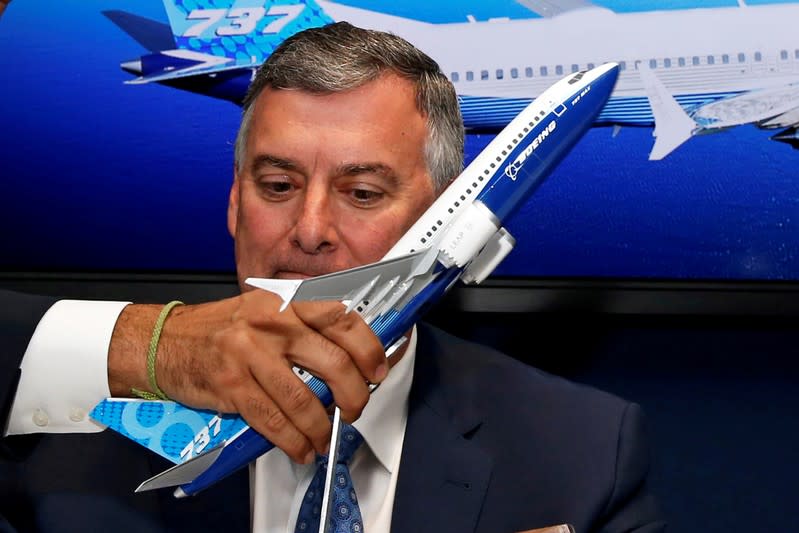 FILE PHOTO: A model of a Boeing 737 MAX is held in front of Kevin McAllister at Le Bourget Airport