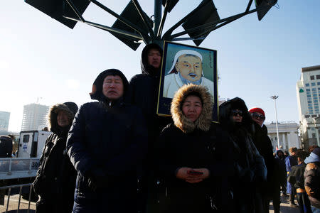 Protesters hold a portrait of Genghis Khan during a demonstration to demand the resignation of Mongolia's parliamentary speaker Enkhbold Miyegombo, at Sukhbaatar Square in Ulaanbaatar, Mongolia December 27, 2018. REUTERS/B. Rentsendorj