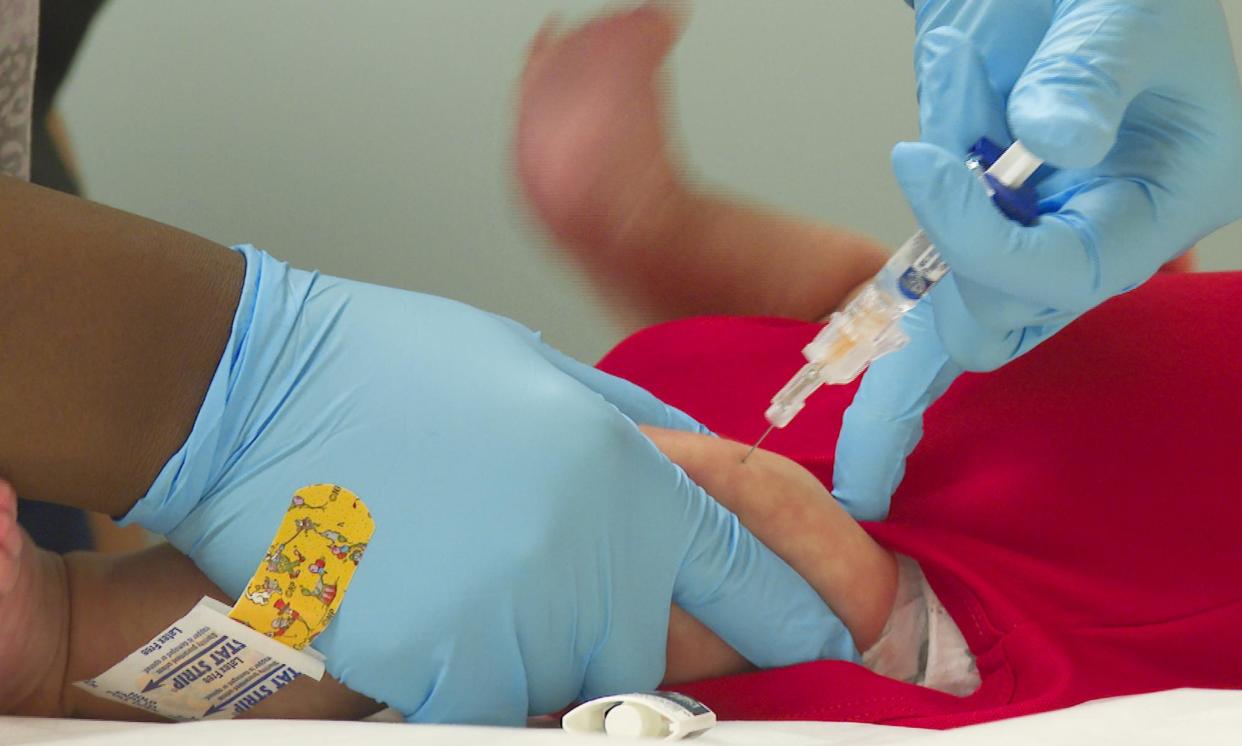 <span>An infant receives a routine vaccination. Experts say the proportion of children having the whooping cough vaccine in their first year also needs to be higher. </span><span>Photograph: Angie Wang/AP</span>