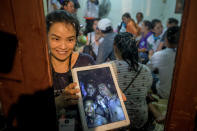 <p>Relatives show photos on tablets of the some of the 12 boys who were found alive in a cave where they’d been lost for over a week along with their soccer coach, in Chiang Rai, Thailand. Gov. Narongsak Osatanakorn announced on July 2 that the boys, aged 11 to 16, and their 25-year-old coach were being rescued from Tham Luang Nang Non cave. (Photo: Linh Pham/Getty Images) </p>