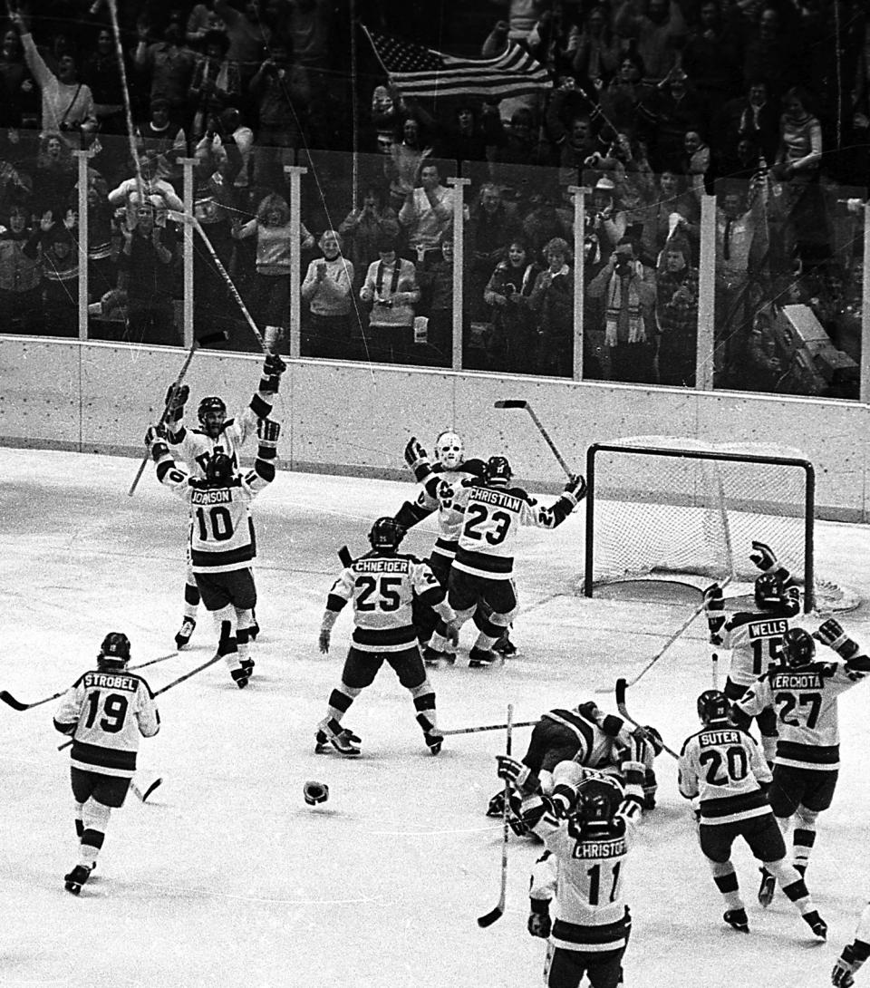 FILE - In this Feb. 22, 1980, file photo, the United States ice hockey team rushes toward goalie Jim Craig after their 4-3 upset win over the Soviet Union in the semi-final round of the 1980 Winter Olympics in Lake Placid, N.Y. The game's significance stretched beyond a rink in Lake Placid to the Cold War, the hostages in Iran, the Soviet invasion of Afghanistan, the energy crisis, and a general malaise hanging over the United States. At Lake Placid and every other Olympics over the past several decades, it was impossible to separate politics from play. (AP Photo/File)