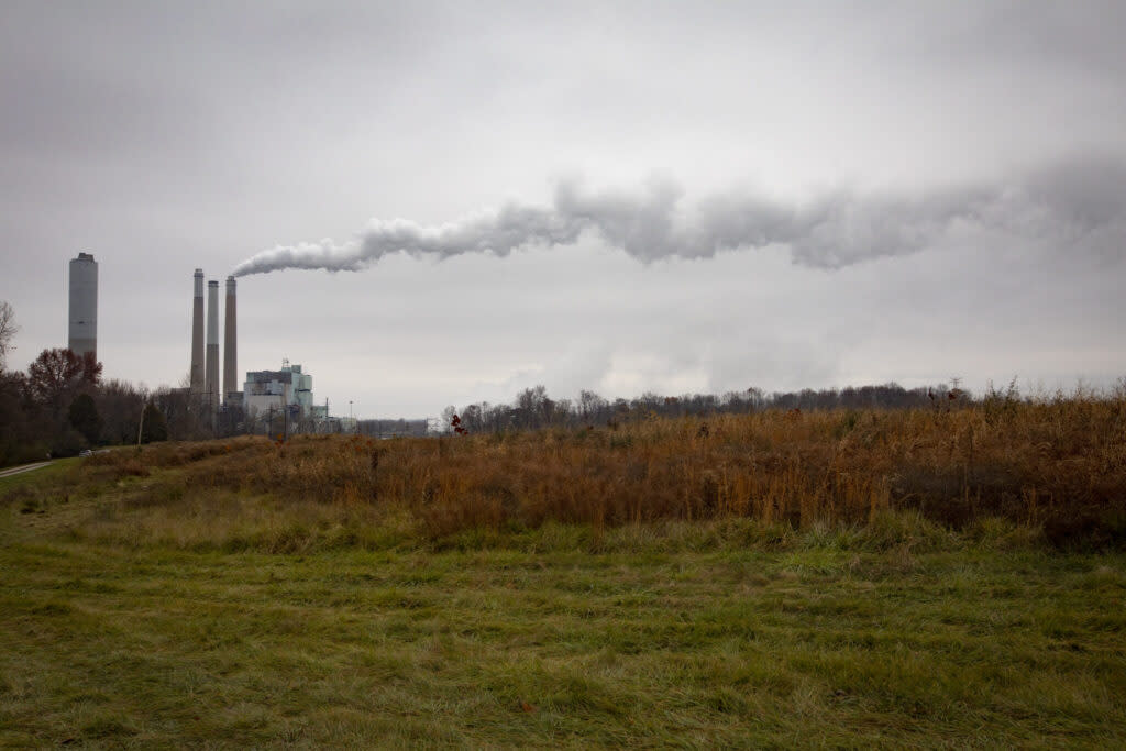 smokestacks belch exhaust into the sky