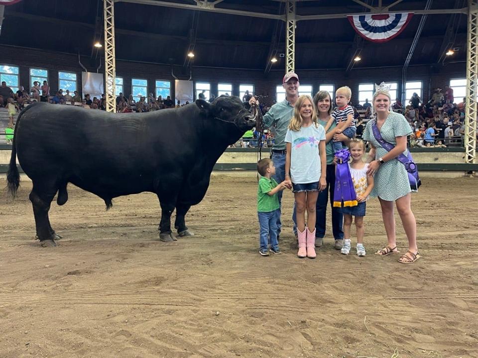 The Dreher family poses with last year's Iowa State Fair Queen McKenna Henrich and their award-winning bull Albert. Weighing in at 3,042 pounds, Albert was crowned the Super Bull Friday night in front of a full crowd at the Livestock Pavilion.