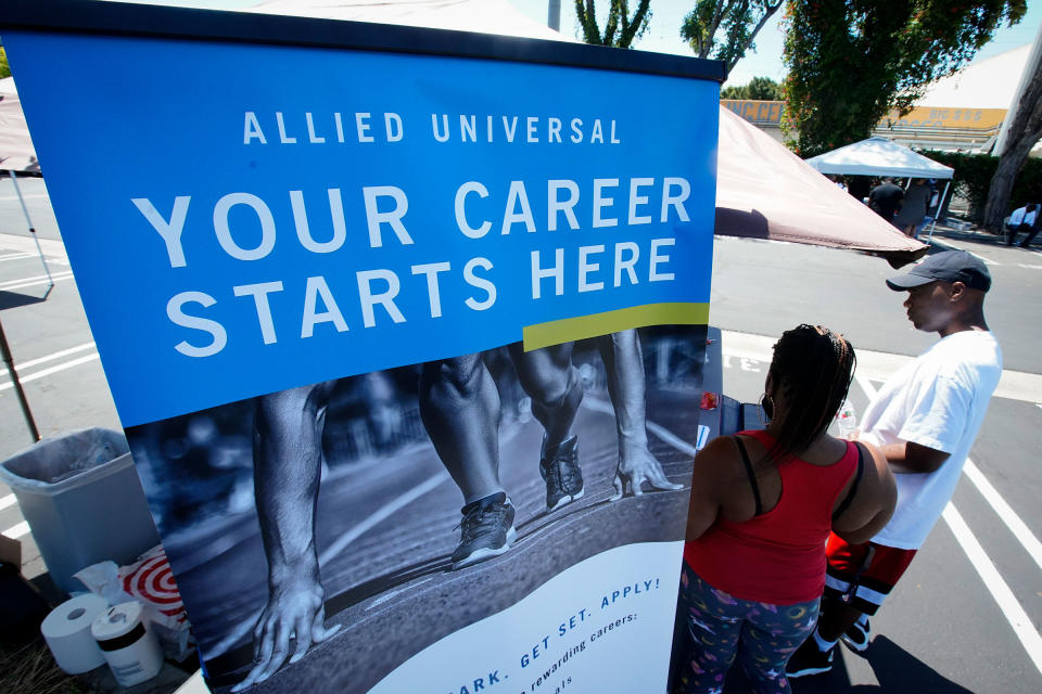 Job seekers fill out an application at a drive up job fair for Allied Universal in in Gardena, Calif. on May 6, 2020.<span class="copyright">Chris Carlson—AP</span>