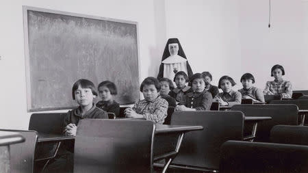 FILE PHOTO: A group of female students and a nun pose in a classroom at Cross Lake Indian Residential School in Cross Lake, Manitoba in a February 1940 archive photo. REUTERS/Canada. Dept. Indian and Northern Affairs/Library and Archives Canada/e011080274/handout via Reuters