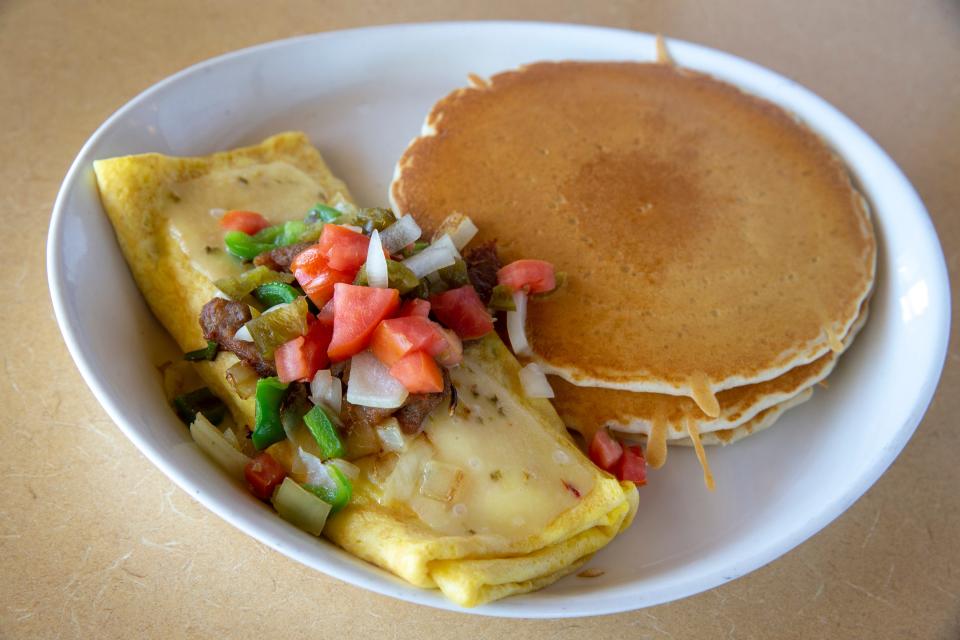 A Southwest three-egg omelets, prepared with pepper jack cheese, cilantro, peppers, onions, sausage and pico de gallo, and served with three buttermilk pancakes, at Middletown Pancake House in Middletown, NJ Wednesday, April 27, 2022.