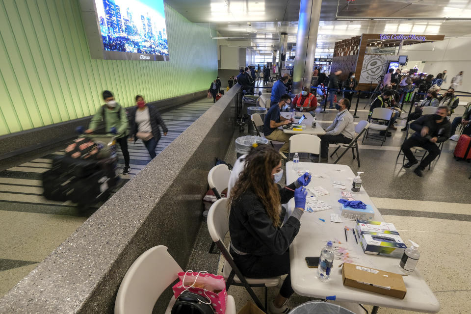 A pop-up COVID-19 vaccination clinic for holiday travelers is set up at the Los Angeles International Airport in Los Angeles, Wednesday Dec. 22, 2021. People traveling during the holiday season can get free COVID-19 vaccinations and booster shots at LAX on two consecutive Wednesdays -- today and Dec. 29. The pop-up clinic, located at the Lower/Arrivals Level of the Tom Bradley International Terminal, will be open from 11 a.m. to 5 p.m. on the two days. (AP Photo/Ringo H.W. Chiu)