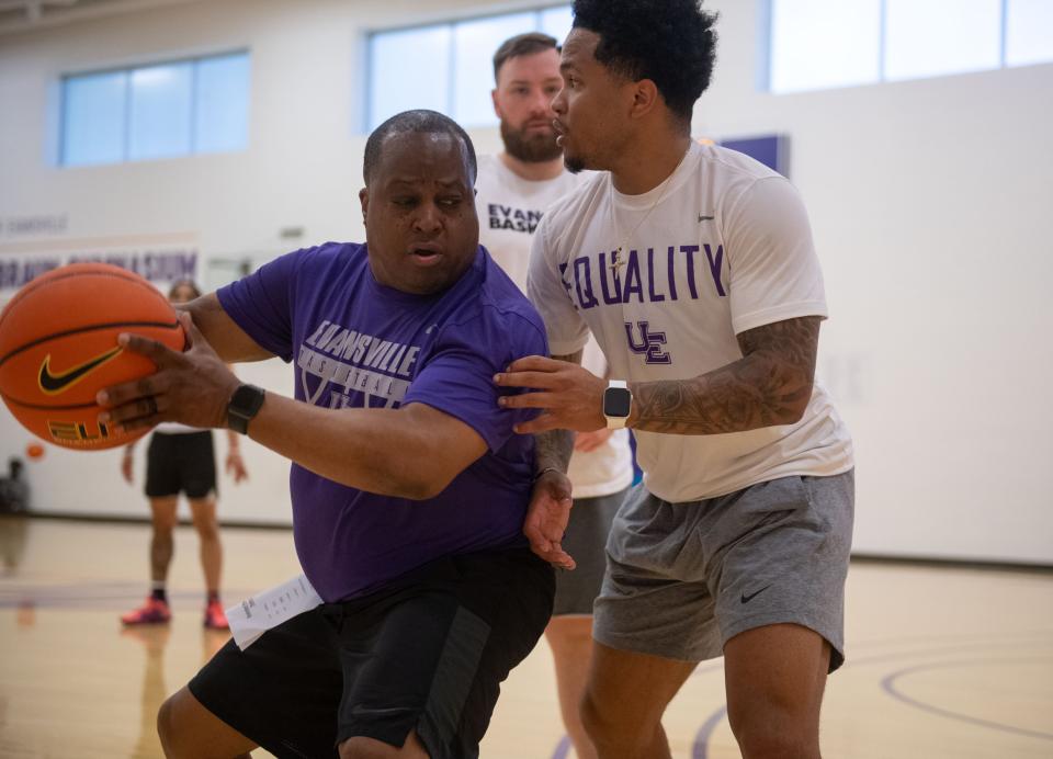 Assistant Coach George Swanson, left, and Graduate Assistant Sammy Dowd, right, demonstrate an exercise at the first UE Men's Basketball summer practice at Fifth Third Bank Practice Facility in Evansville, Ind., Tuesday, June 21, 2022.