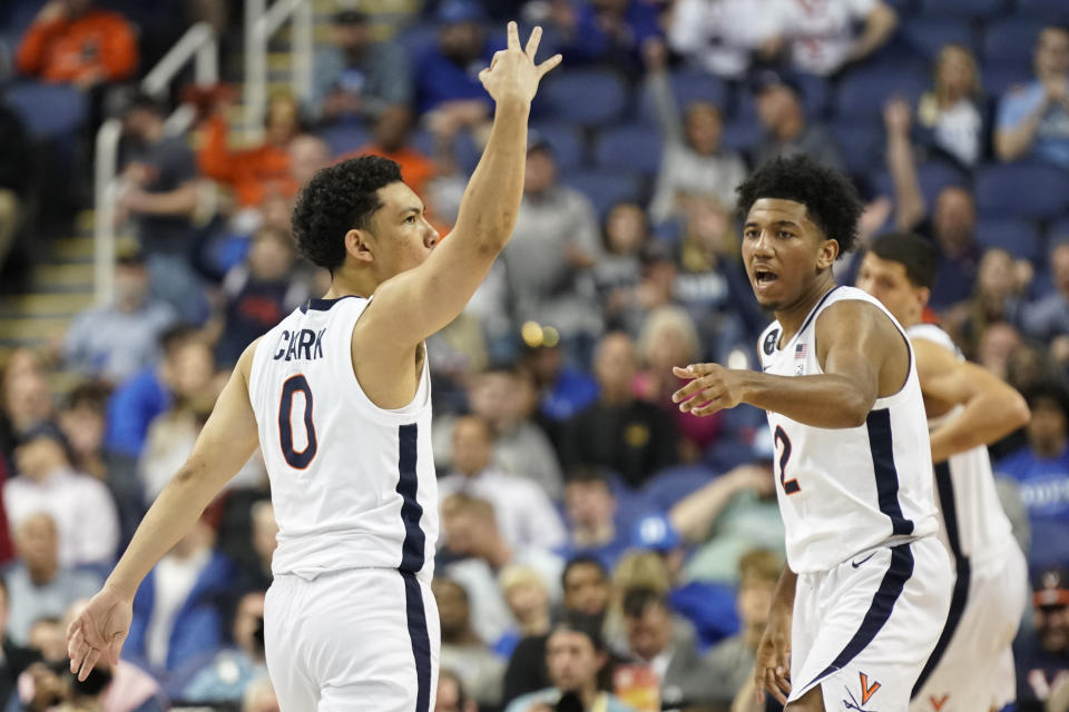 Virginia guard Kihei Clark (0) celebrates after making a 3-point basket against Clemson during the second half of an NCAA college basketball game at the Atlantic Coast Conference Tournament in Greensboro, N.C., Friday, March 10, 2023. (AP Photo/Chuck Burton)