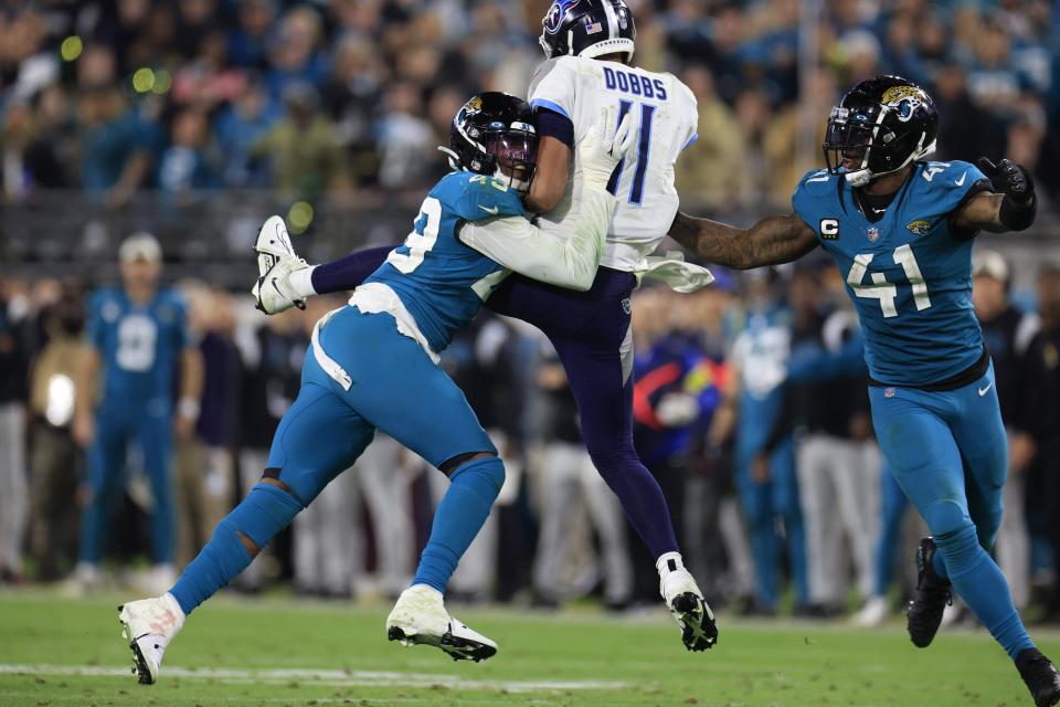 Jacksonville Jaguars defensive end Arden Key (49) pressured Tennessee Titans quarterback Joshua Dobbs (11) with teammate linebacker Josh Allen (41) during the fourth quarter of an NFL football regular season matchup AFC South division title game Saturday, Jan. 7, 2023 at TIAA Bank Field in Jacksonville. The Jacksonville Jaguars held off the Tennessee Titans 20-16. [Corey Perrine/Florida Times-Union]