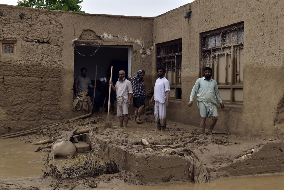 People clean up their damaged homes after heavy flooding in Baghlan province in northern Afghanistan Saturday, May 11, 2024. Flash floods from seasonal rains in Baghlan province in northern Afghanistan killed dozens of people on Friday, a Taliban official said. (AP Photo/Mehrab Ibrahimi)