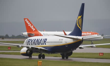 A Ryanair aircraft taxis behind an easyJet aircraft at Manchester Airport in Manchester, Britain June 28, 2016. REUTERS/Andrew Yates/File Photo