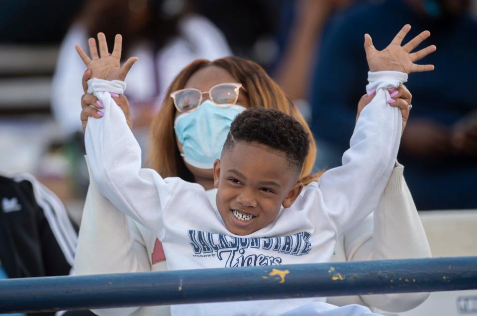 Deklan Anderson, 5, and his cousin Tarsh Paris cheered on Jackson State during the Tigers' rivalry game against Southern on April 3.