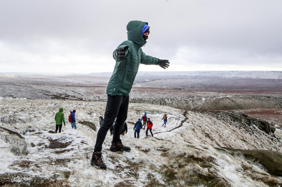 Hikers in snow on Bleaklow Moor in the Peak district of Derbyshire, after days of wet and wintry weather across the Christmas break, with a cold snap and icy conditions still to come.