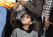 Girl looks on before she boarded a United Nations plane which will carry her and other patients to Amman, Jordan in the first flight of a medical air bridge from Sanaa, Yemen