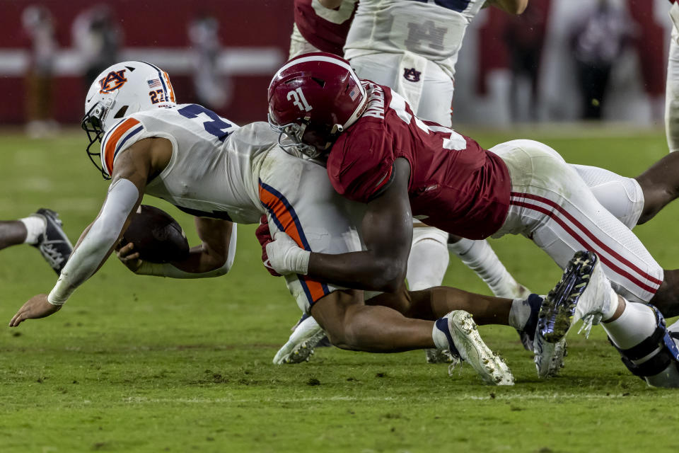 Alabama linebacker Will Anderson Jr. (31) tackles Auburn running back Jarquez Hunter, left, during the second half of an NCAA college football game, Saturday, Nov. 26, 2022, in Tuscaloosa, Ala. (AP Photo/Vasha Hunt)