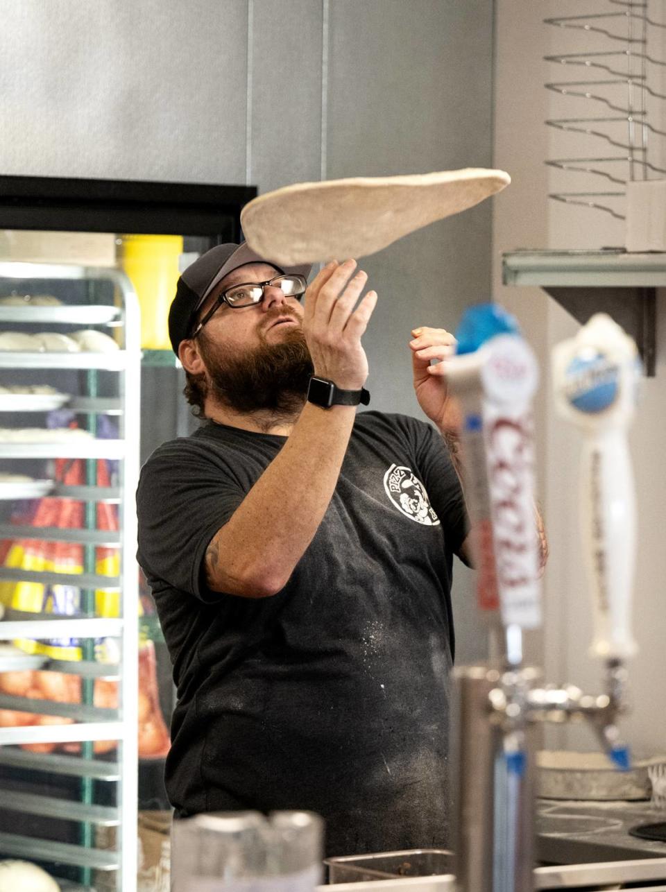 Brian Davis tosses makes a pizza at Pizza Factory in Turlock, Calif., Tuesday, Oct. 17, 2023.