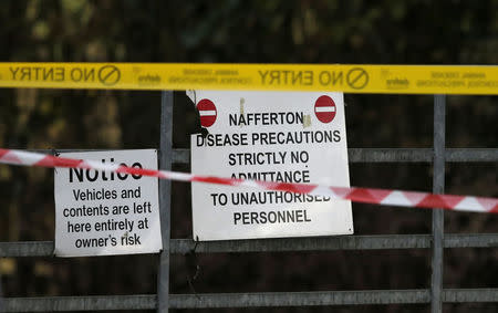 Police tape and warning signs are seen outside a duck farm in Nafferton, northern England November 17, 2014. REUTERS/Phil Noble