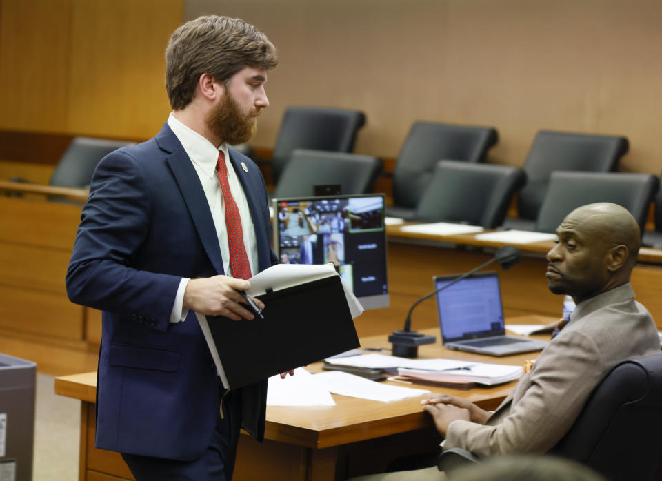 Donald Wakeford, left, attorney for the grand jury, returns to his desk after presenting arguments to join attorney Nathan Wade during a hearing on Georgia Governor Brian Kemp's motion to quash his subpoena from the special purpose grand jury in Atlanta on Thursday, Aug. 25, 2022. (Bob Andres /Atlanta Journal-Constitution via AP)