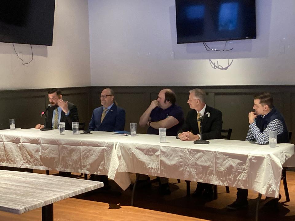 Joshua Smith (left) gives his closing remarks at the Libertarian Party of Iowa's debate alongside Lars Mapstead, moderator Marco Battaglia, Mike ter Maat and Chase Oliver at Felix & Oscar's restaurant on Jan. 14, 2024, in Des Moines.