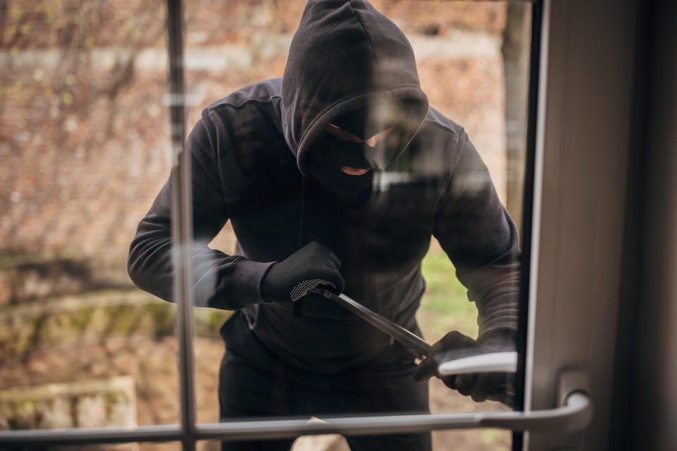 person breaking into a house