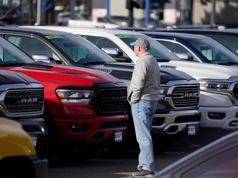 A car dealership lot with Ram pickup trucks.