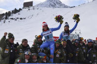 Italy's Federica Brignone, first placed, left, celebrates with tIaly's Elena Curtoni, second placed, on the podium of an alpine ski, women's World Cup super-G in St. Moritz, Switzerland, Sunday, Dec. 12, 2021. (AP Photo/Marco Trovati)