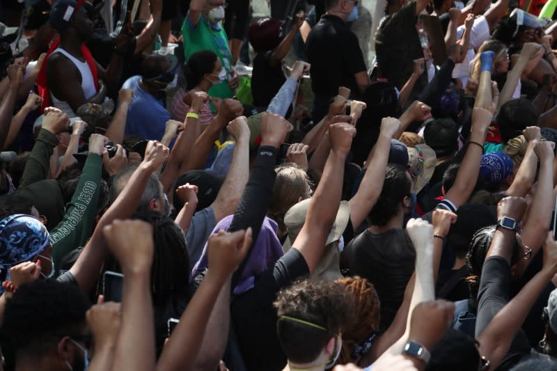 Protesters raise hands in solidarity during rally against the death in Minneapolis police custody of George Floyd, in Houston