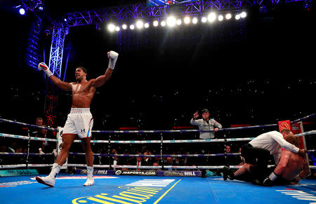 Boxing - Anthony Joshua v Alexander Povetkin - WBA Super, IBF, WBO & IBO World Heavyweight Titles - Wembley Stadium, London, Britain - September 22, 2018 Anthony Joshua reacts after knocking down Alexander Povetkin Action Images via Reuters/Andrew Couldridge