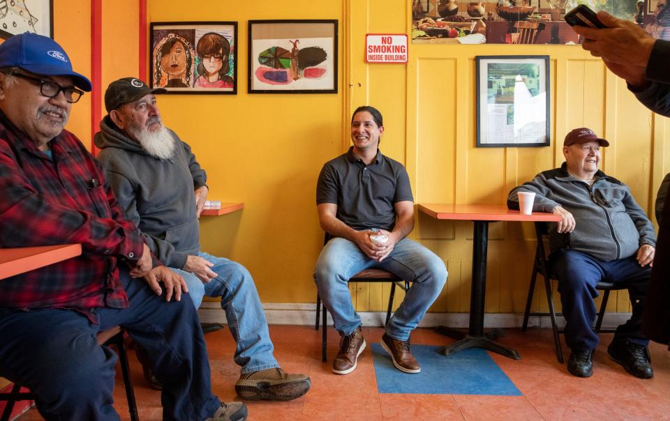 Abel Jaime, left, Julio Cesar Gutierrez, Gabriel Gutierrez, middle, and Lee SanMiguel sit inside the temporary Donut Villa location in southwest Detroit on Wednesday, March 29, 2023. The real Donut Villa location is under renovation.