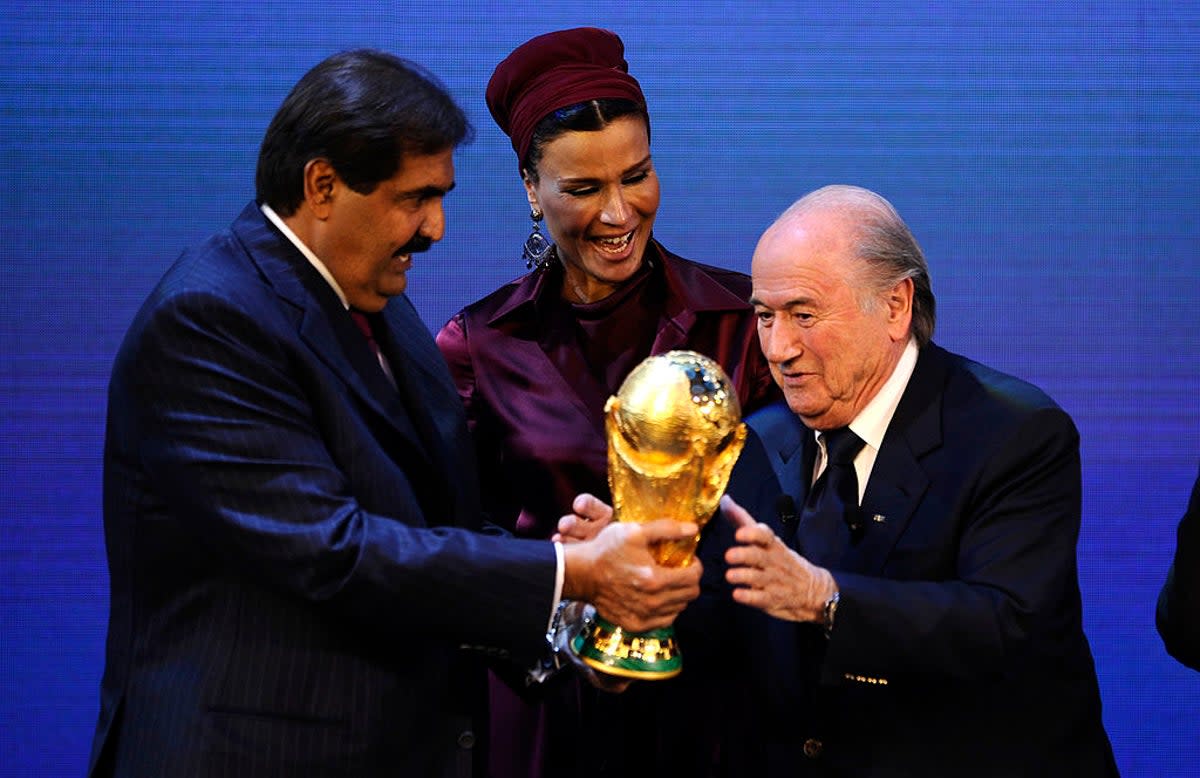 Sepp Blatter hands over the World Cup trophy to the Emir Qatar Sheikh Hamad bin Khalifa Al-Thani in 2010 (AFP via Getty Images)