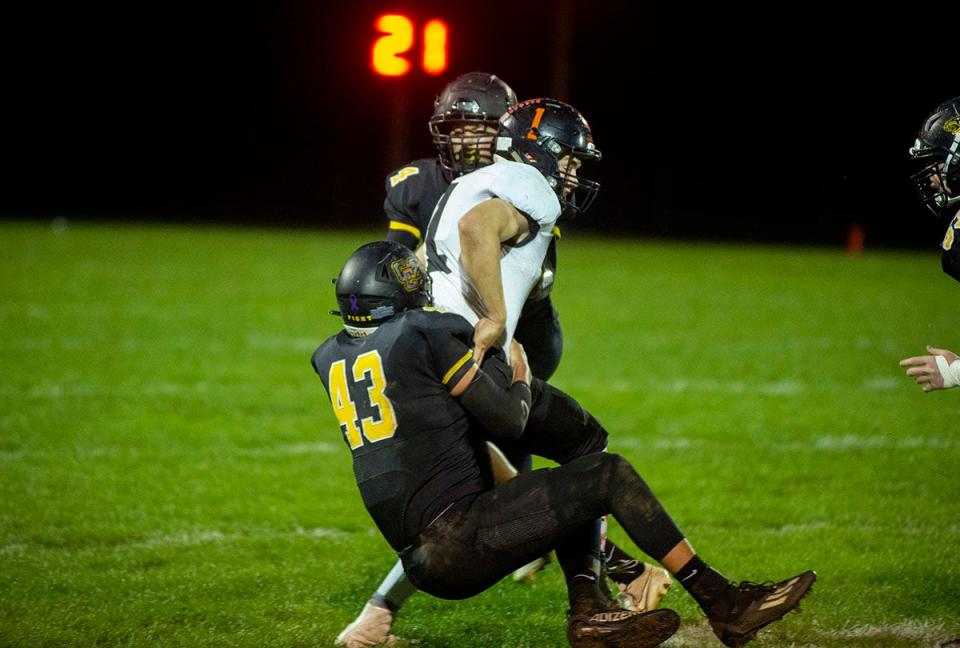 Colonel Crawford's Carson Feichtner brings down Seneca East's Gavin Hargis.