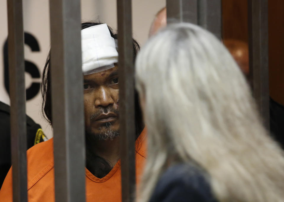 Adel Sambrano Ramos, left, huddles with his court-appointed attorney, Diane Howard, during his first court appearance in the shooting death of Sacramento Police officer Tara O'Sullivan in Sacramento County Superior Court in Sacramento, Calif., Monday, June 24, 2019. Ramos did not enter a plea. (AP Photo/Rich Pedroncelli)