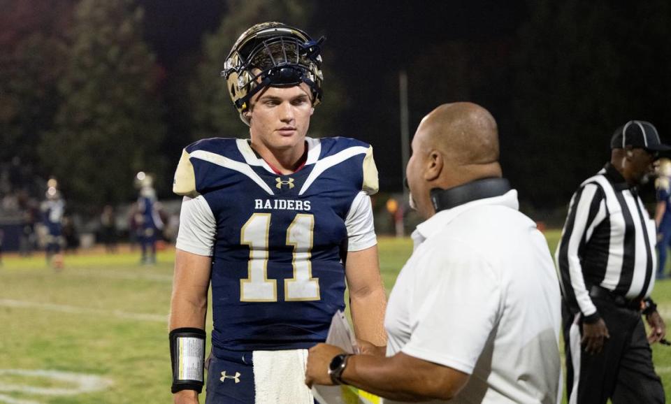 Central Catholic quarterback TP Wentworth talks to his coach Billy Hylla during the Sac-Joaquin Section Division I quarterfinal game with Edison at Central Catholic High School in Modesto, Calif., Friday, Nov. 10, 2023.