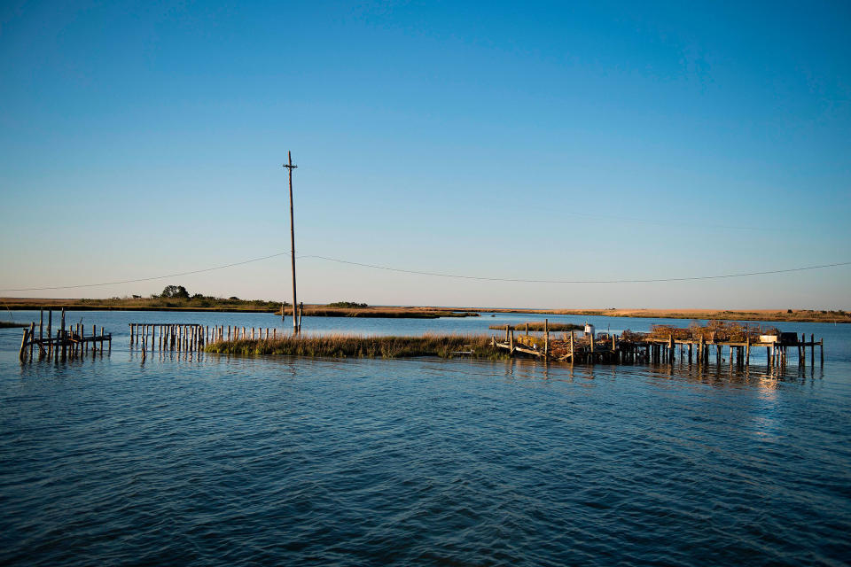 <p>Supports jet out of the water where crab shanties used to stand on a patch of land now surrounded by water in Tangier, Virginia, May 15, 2017, where climate change and rising sea levels threaten the inhabitants of the slowly sinking island.<br> (Jim Watson/AFP/Getty Images) </p>