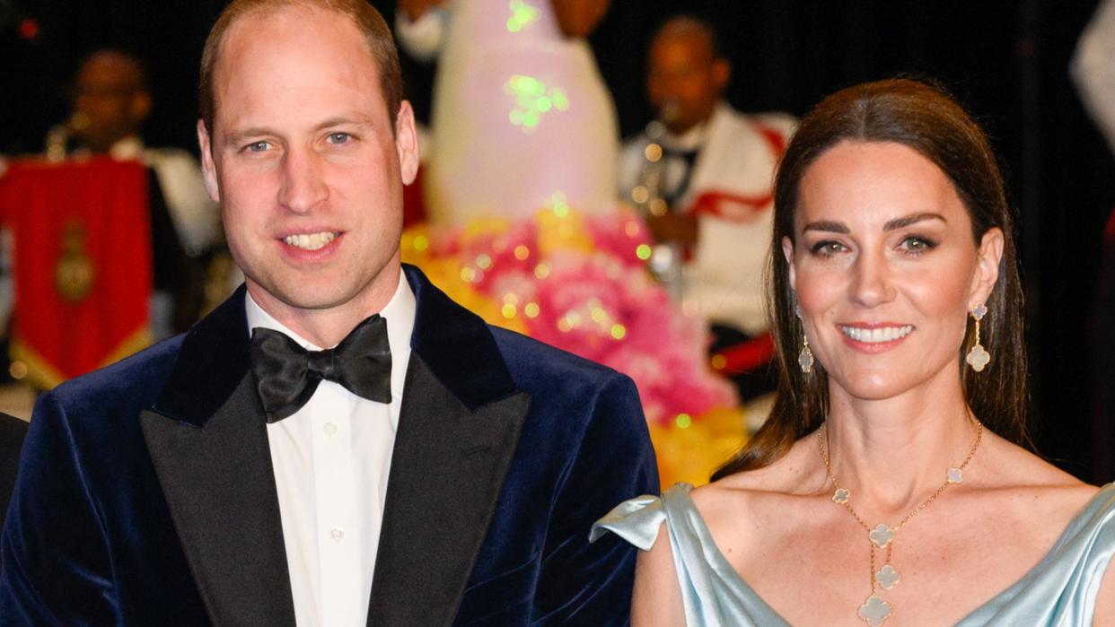 Prince William in a velvet jacket and Princess Kate in a blue silk dress