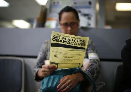 Arminda Murillo, 54, reads a leaflet on Obamacare at a health insurance enrollment event in Cudahy, California, U.S. March 27, 2014. REUTERS/Lucy Nicholson/File Photo