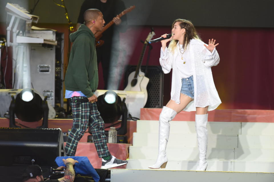 In this handout provided by 'One Love Manchester' benefit concert (L) Pharrell Williams and Miley Cyrus perform on stage on June 4, 2017 in Manchester, England. Donate at www.redcross.org.uk/love&nbsp;