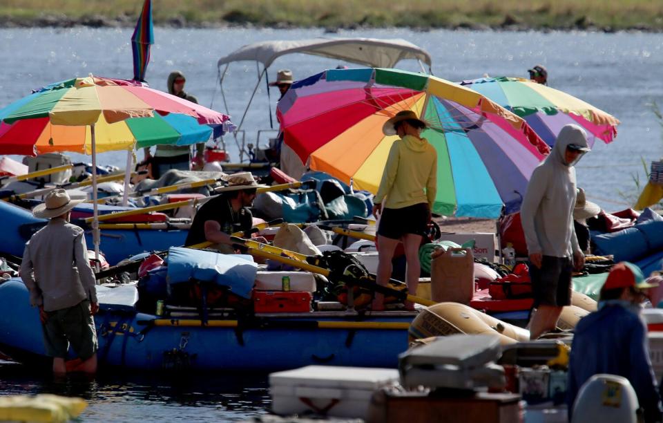 Whitewater river rafting operators set up at Lee's Ferry before taking another batch of visitors into the Grand Canyon.