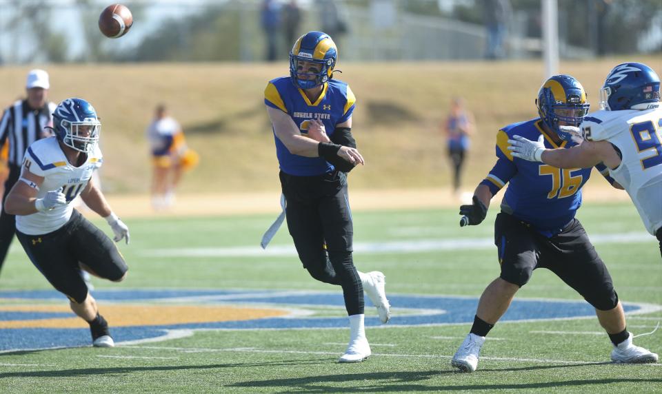 Angelo State University quarterback Zach Bronkhorst fires a pass as Braxton Webb, 76, provides protection during an NCAA Division II second-round playoff game against Nebraska-Kearney at LeGrand Stadium at 1st Community Credit Union Field on Saturday, Nov. 27, 2021. Webb is a former San Angelo Central High School standout who transferred from SMU.